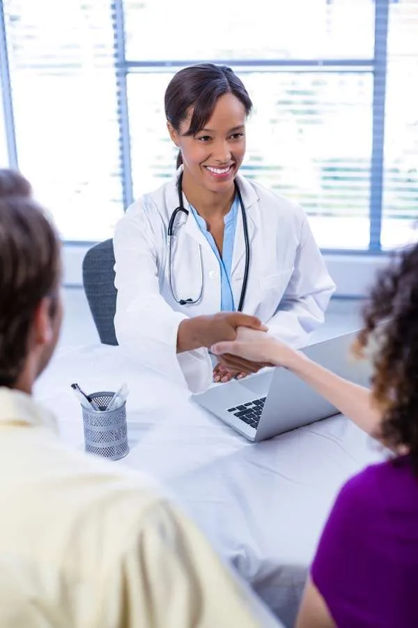 Doctor shaking hands with a patient after a consultation
