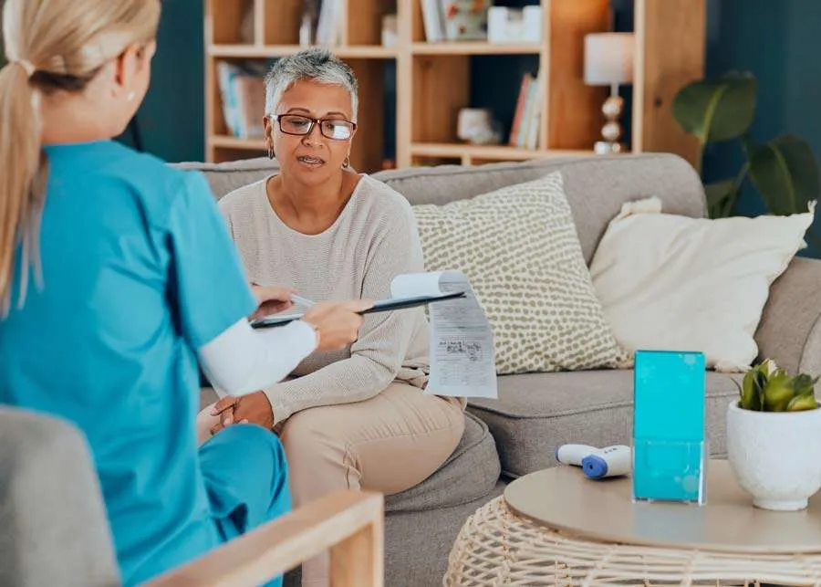 Nurse with clipboard providing specialist care